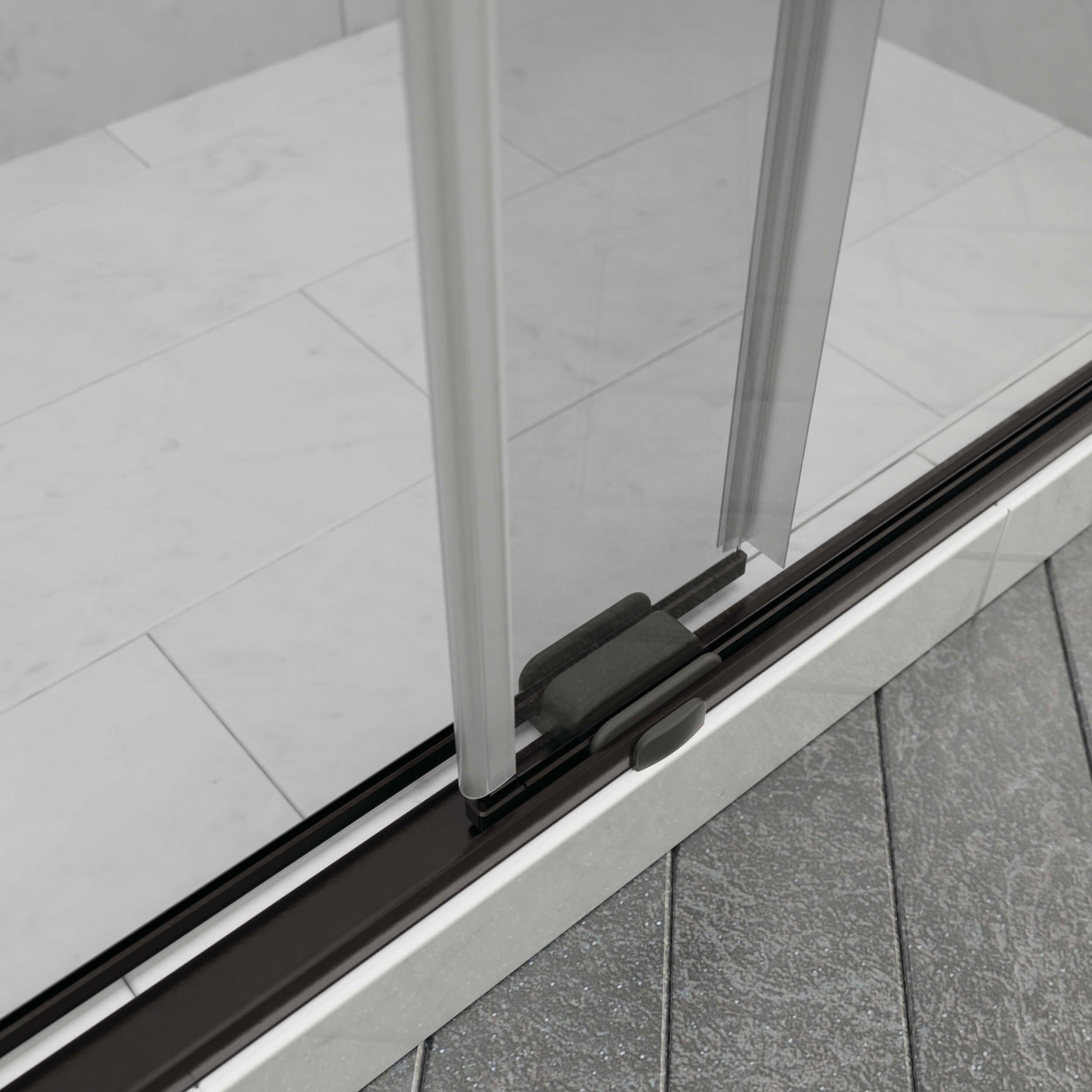 Close-up of a sliding shower door with a black track on a tiled floor.