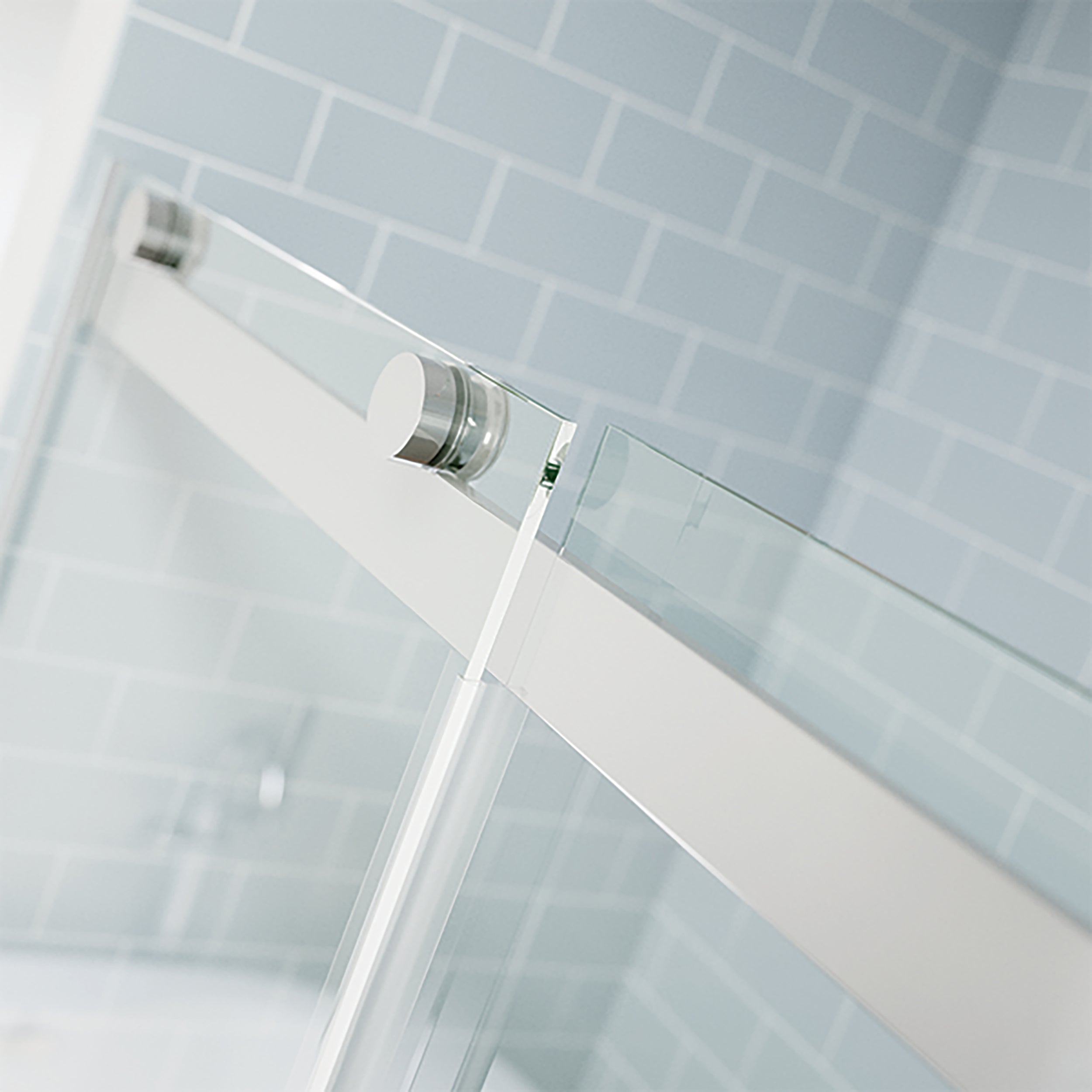 Closeup photo of silver shower door top track